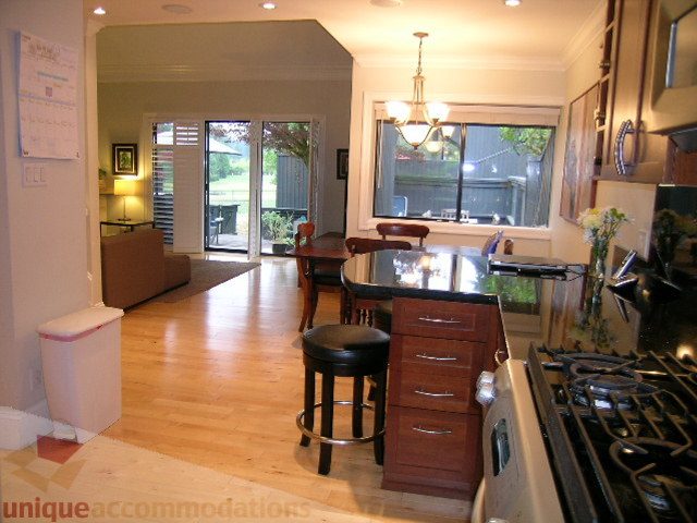 Bright kitchen with hardwood floors and a view of the backyard. - 405 - 4001 Mount Seymour Pkwy, North Vancouver