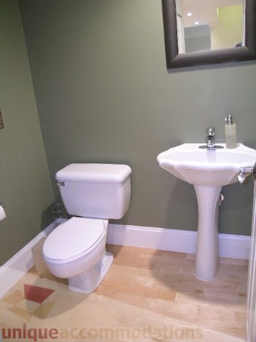 Bathroom with white fixtures and wooden flooring. - 405 - 4001 Mount Seymour Pkwy, North Vancouver
