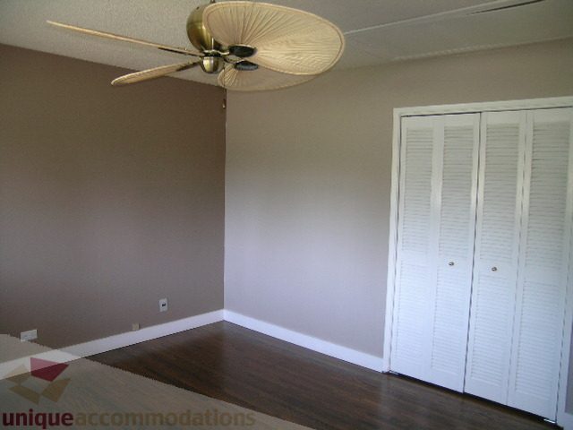 Spacious bedroom with hardwood floors and closet doors. - 1350 14th Street, West Vancouver