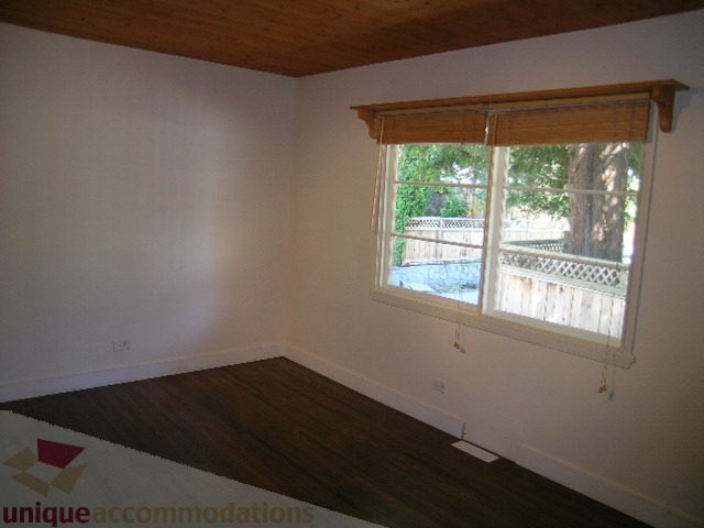 Bright living room with hardwood floors and a view of the backyard. - 1350 14th Street, West Vancouver