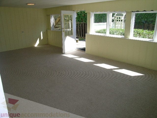 Bright living room with large windows and carpeted floor. - 1350 14th Street, West Vancouver