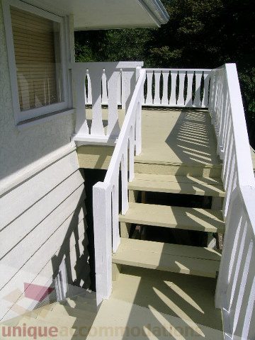 Furnished porch with white railings and steps leading up to the house. - 1350 14th Street, West Vancouver