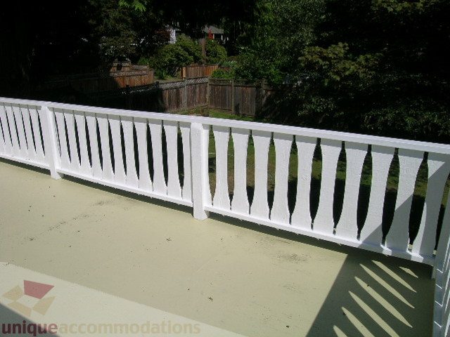 Furnished balcony with white railing and shadowed ground. - 1350 14th Street, West Vancouver