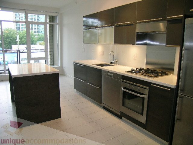 Bright kitchen with modern stainless steel appliances, sleek countertops, and city view. - 406 - 1252 Hornby Street, Vancouver Downtown