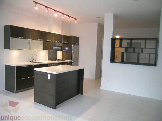 Bright kitchen with modern black and white cabinetry, sleek countertops, and a clean open-concept layout.