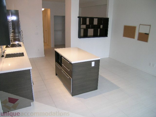Furnished kitchen with white countertops and modern cabinetry. - 406 - 1252 Hornby Street, Vancouver Downtown