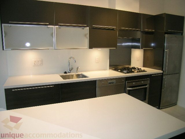 Bright kitchen with modern black cabinets, white countertops, and stainless steel appliances. - 406 - 1252 Hornby Street, Vancouver Downtown
