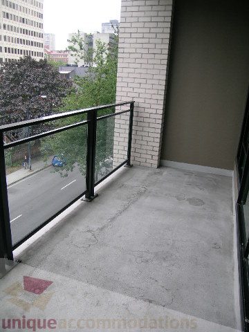 Furnished balcony with city view and brick wall. - 406 - 1252 Hornby Street, Vancouver Downtown