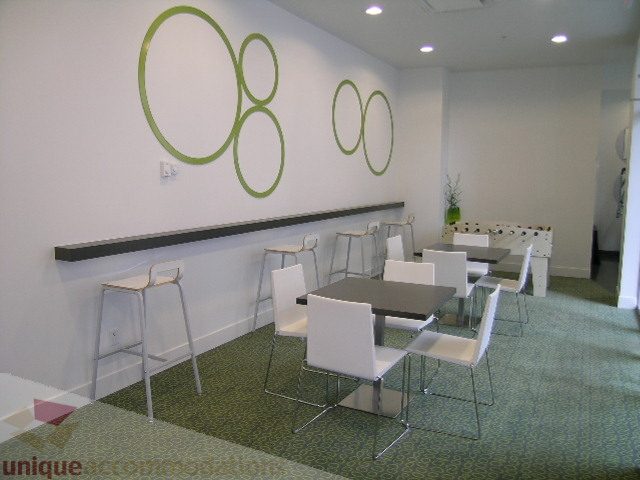 Furniture-filled dining area with modern chairs and green wall decor. - 406 - 1252 Hornby Street, Vancouver Downtown