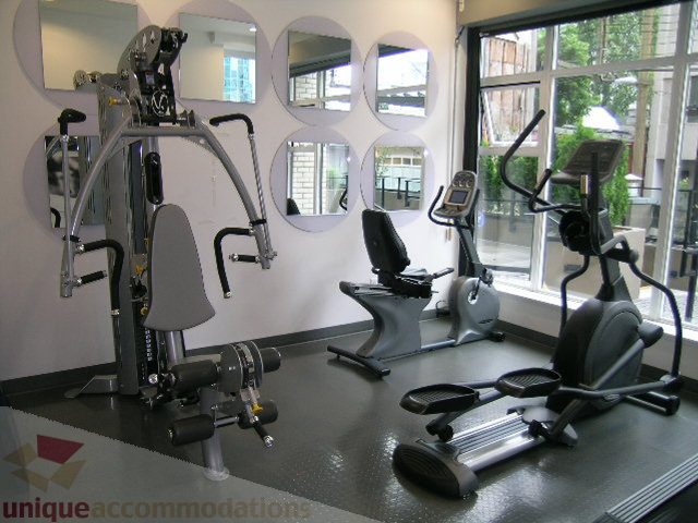 Bright fitness room with exercise equipment and large mirrors. - 406 - 1252 Hornby Street, Vancouver Downtown