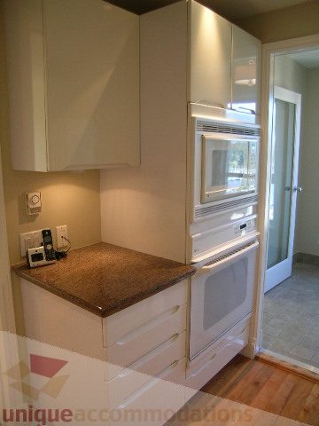 Bright kitchen with white cabinets, granite countertops, and hardwood floors. - 1602 - 560 Cardero, Vancouver Downtown