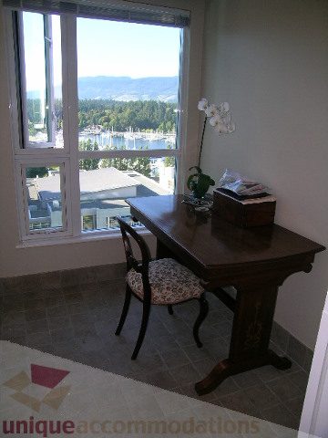Bright dining area with city view and wooden furniture. - 1602 - 560 Cardero, Vancouver Downtown