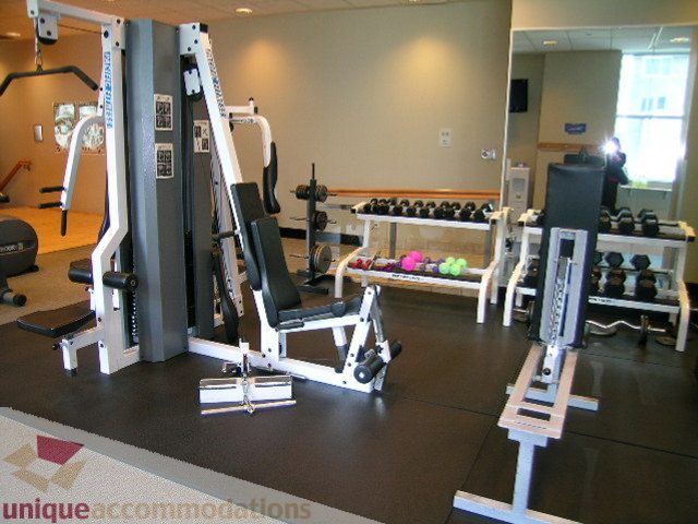 Fitness room with weight machines and dumbbells, clean and organized. - 1602 - 560 Cardero, Vancouver Downtown