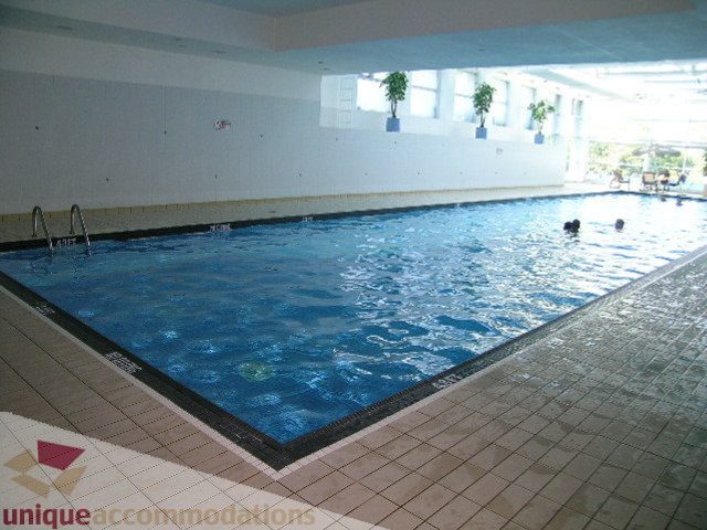 Spacious indoor pool area with tiled flooring and water jets. - 1602 - 560 Cardero, Vancouver Downtown
