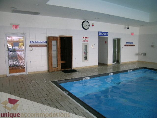Spacious indoor pool area with tiled floors and clock. - 1602 - 560 Cardero, Vancouver Downtown
