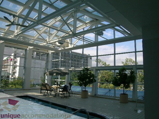 Furnished living room with glass ceiling, city view, and outdoor seating area. - 1602 - 560 Cardero, Vancouver Downtown
