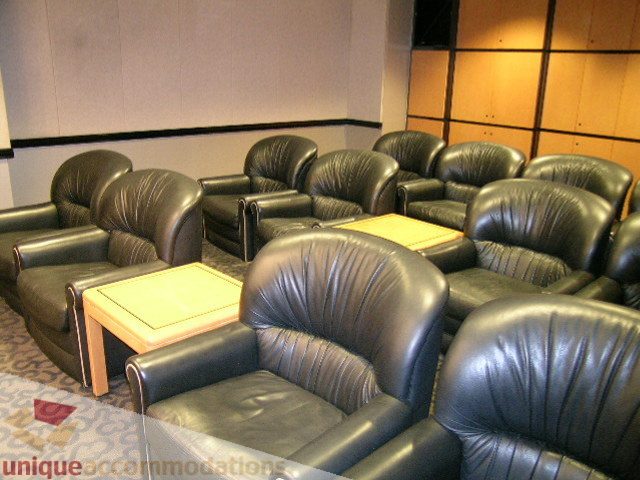 Furnished living room with leather armchairs and wooden coffee tables. - 1602 - 560 Cardero, Vancouver Downtown