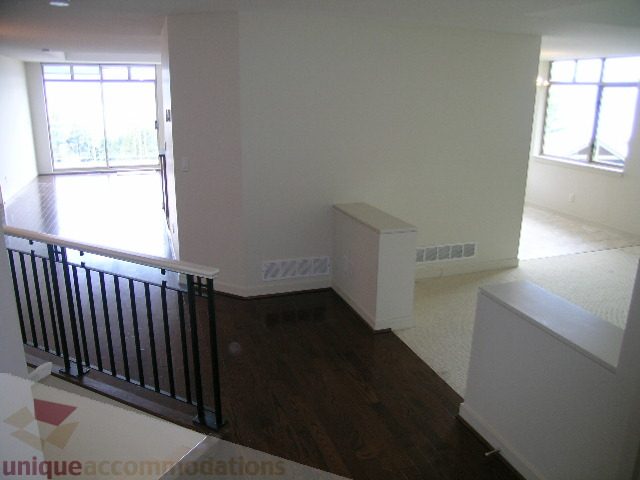 Spacious living room with hardwood floors and large windows, perfect for relaxation. - 8601 Seascape Place, West Vancouver