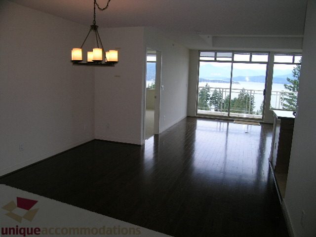Spacious living room with hardwood floors and a stunning view of the ocean. - 8601 Seascape Place, West Vancouver