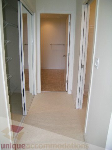 Spacious walk-in closet with mirrored doors and built-in shelves. - 8601 Seascape Place, West Vancouver