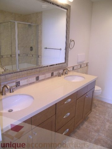 Spacious bathroom with dual sinks, large mirror, and tiled countertop. - 8601 Seascape Place, West Vancouver