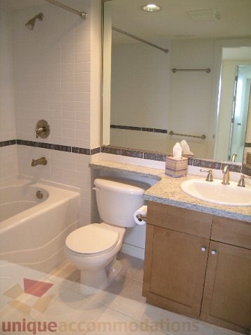Bathroom with granite countertops, modern fixtures, and a large mirror. - 8601 Seascape Place, West Vancouver