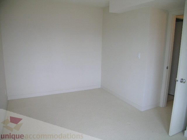 Spacious den with white walls and built-in storage, perfect for a home office or relaxation. - 8601 Seascape Place, West Vancouver