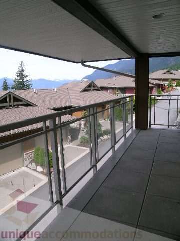 Spacious balcony with modern railings and scenic mountain views. - 8601 Seascape Place, West Vancouver