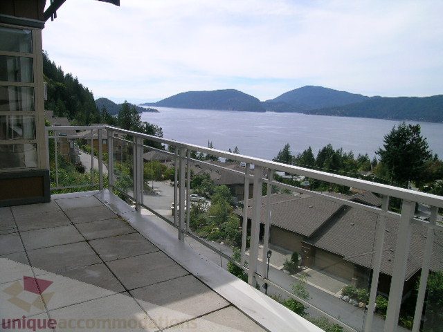 Spacious balcony with stunning views of the ocean and mountains, perfect for relaxing. - 8601 Seascape Place, West Vancouver