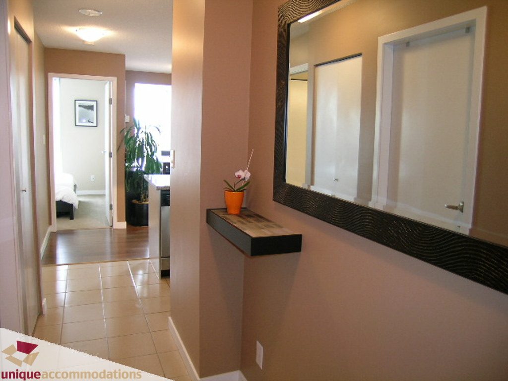 Furnished living room with hardwood floors and a modern kitchen counter. - 316 - 1082 Seymour, Vancouver Downtown