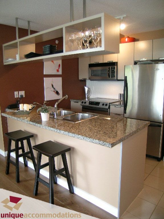 Bright kitchen with granite countertops, stainless steel appliances, and a modern design. - 316 - 1082 Seymour, Vancouver Downtown