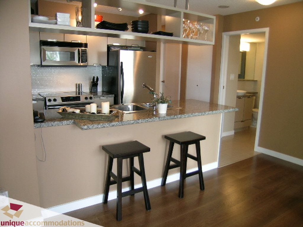Bright kitchen with granite countertops, hardwood floors, and a modern design. - 316 - 1082 Seymour, Vancouver Downtown