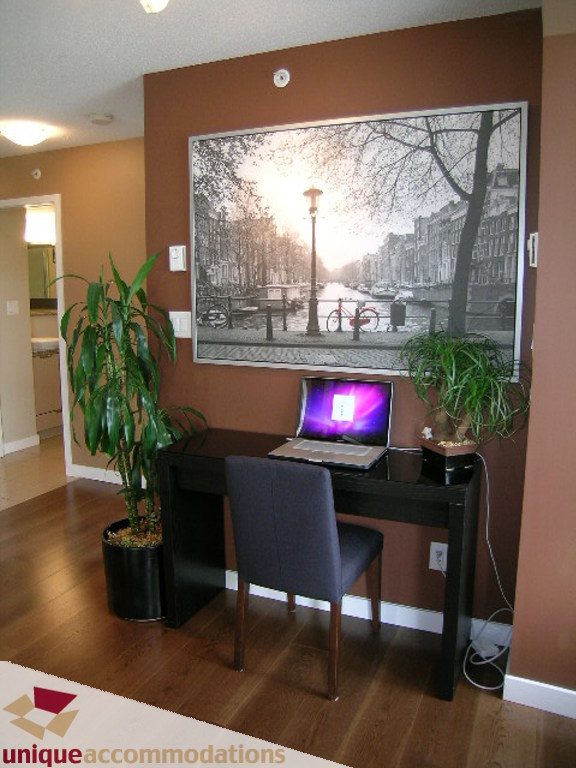 Furnished office space with hardwood floors, desk, laptop, and potted plants. - 316 - 1082 Seymour, Vancouver Downtown