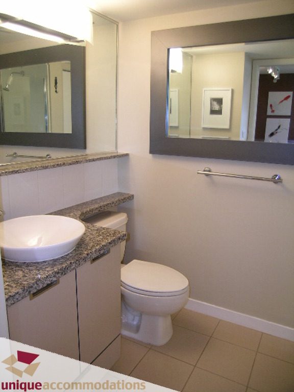 Bright bathroom with granite countertops and a modern toilet. - 316 - 1082 Seymour, Vancouver Downtown