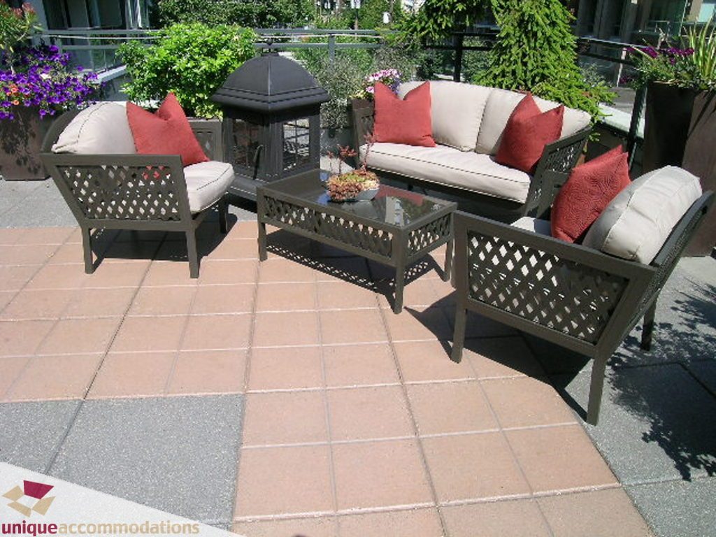 Furnished patio with outdoor furniture, potted plants, and a glass-top table. - 316 - 1082 Seymour, Vancouver Downtown