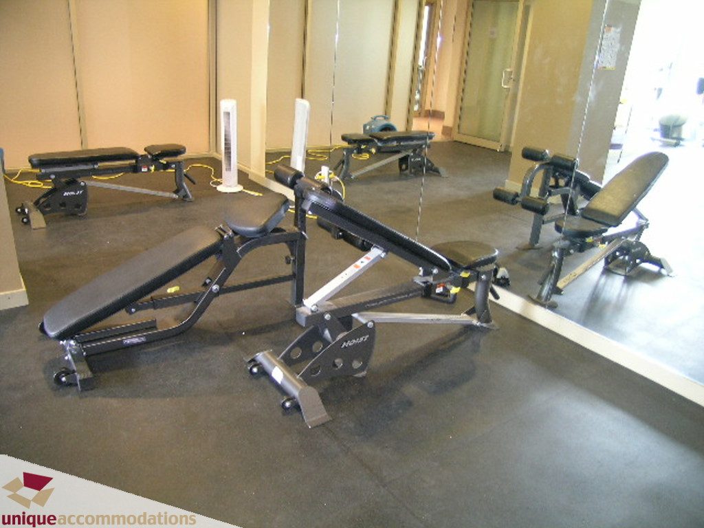 Bright gym with weight benches and mirrors, clean and organized. - 316 - 1082 Seymour, Vancouver Downtown