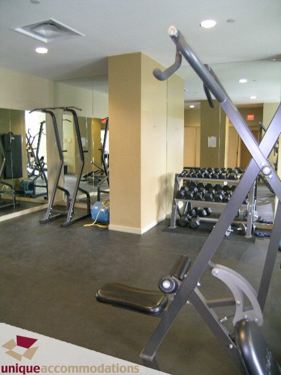 Fitness room with mirrors, weights, and cardio equipment. - 316 - 1082 Seymour, Vancouver Downtown