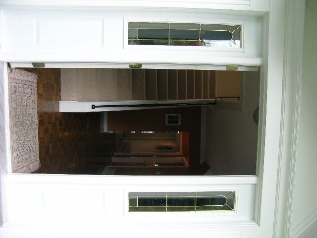 Staircase leading to upper level with hardwood floors and a view of the living area below. - 992 Canyon Blvd, North Vancouver