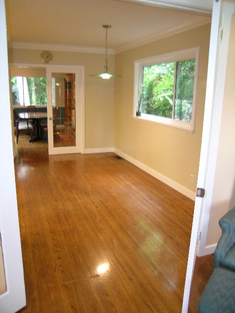 Bright dining room with hardwood floors and large window view. - 992 Canyon Blvd, North Vancouver