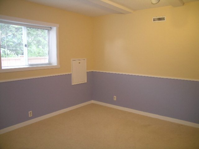 Bright bedroom with built-in shelves and carpeted floor. - 992 Canyon Blvd, North Vancouver