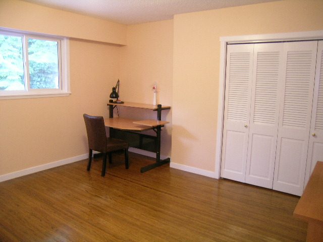 Bright dining area with hardwood floors and white cabinets. - 992 Canyon Blvd, North Vancouver