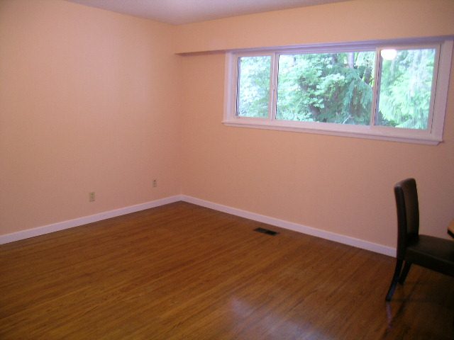Bright dining area with hardwood floors and a large window view. - 992 Canyon Blvd, North Vancouver