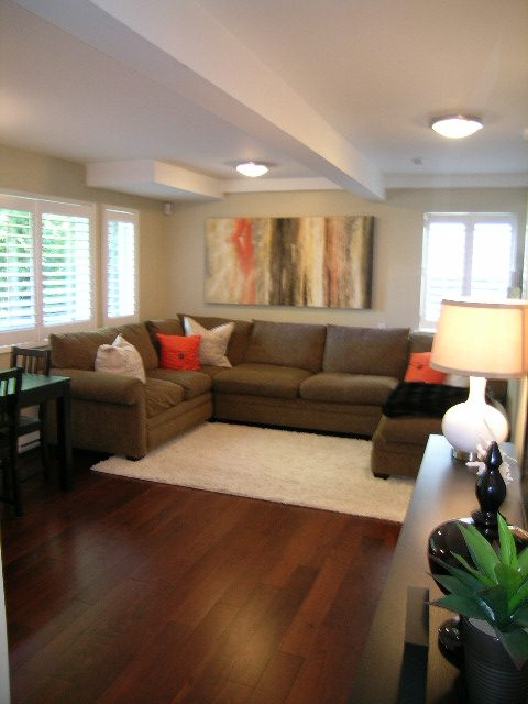 Spacious living room with hardwood floors, modern artwork, and comfortable seating. - Suite - 3844 West 14th Ave, Vancouver West Side