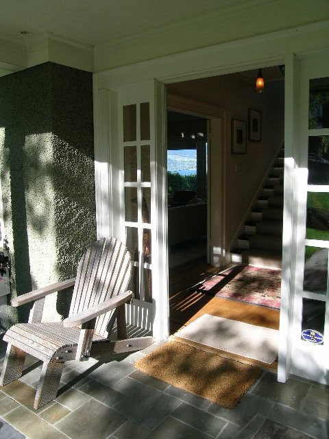 Bright front porch with wooden rocking chairs and a city view. - 4663 Bellevue Drive, Vancouver West Side
