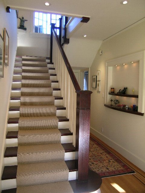 Staircase with wooden banister and carpeted steps leading to upper level. - 4663 Bellevue Drive, Vancouver West Side