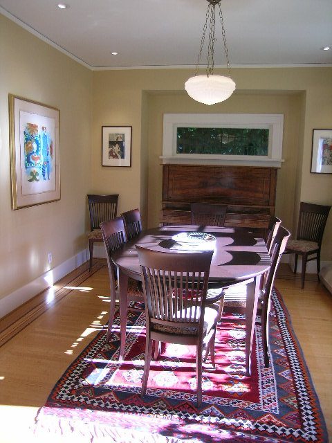 Dining room with wooden chairs, patterned rug, and piano in corner. - 4663 Bellevue Drive, Vancouver West Side