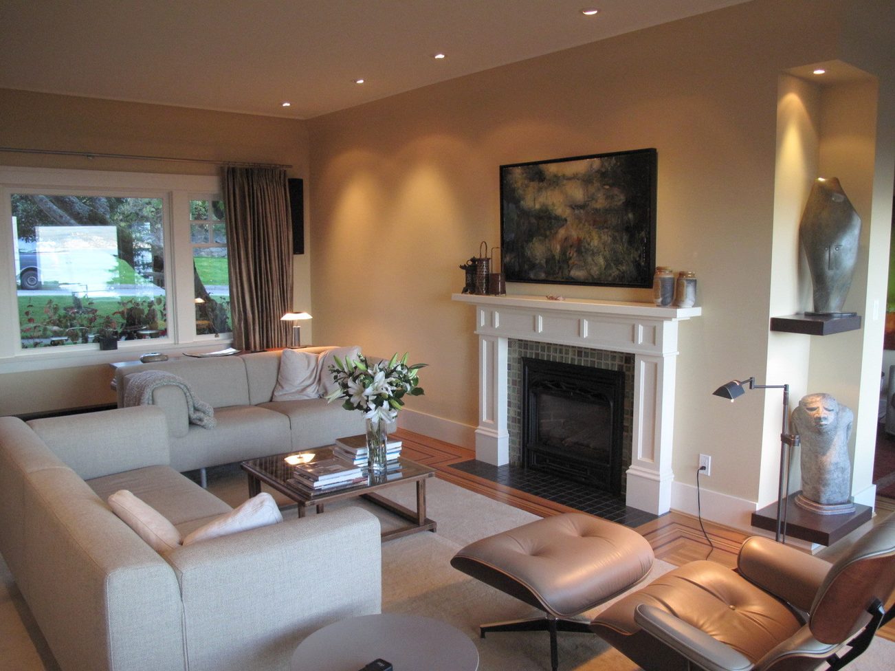 Spacious living room with modern furniture, fireplace, and large windows. - 4663 Bellevue Drive, Vancouver West Side