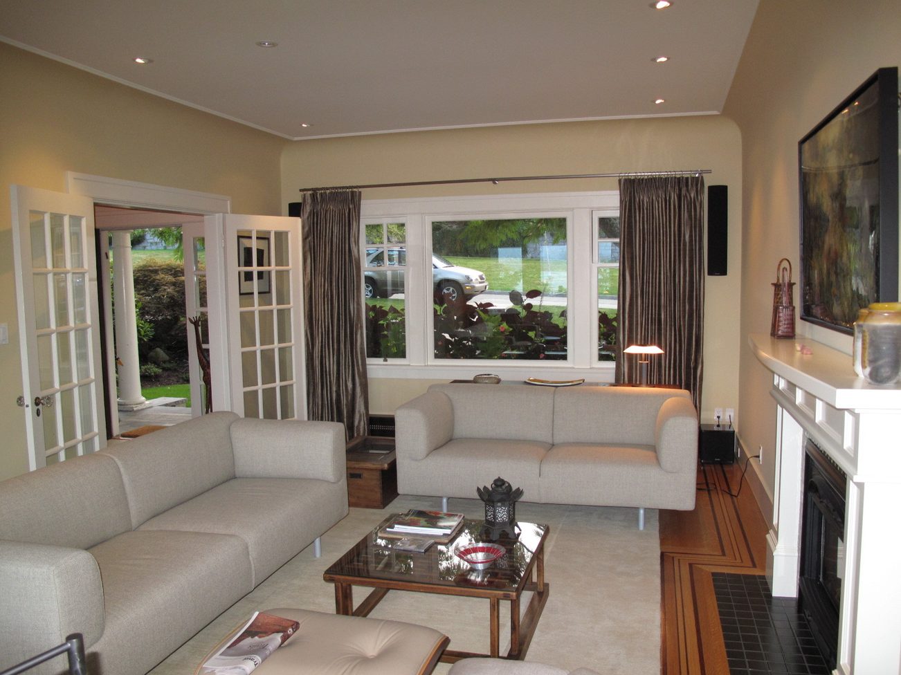 Spacious living room with large windows, modern furniture, and hardwood floors. - 4663 Bellevue Drive, Vancouver West Side