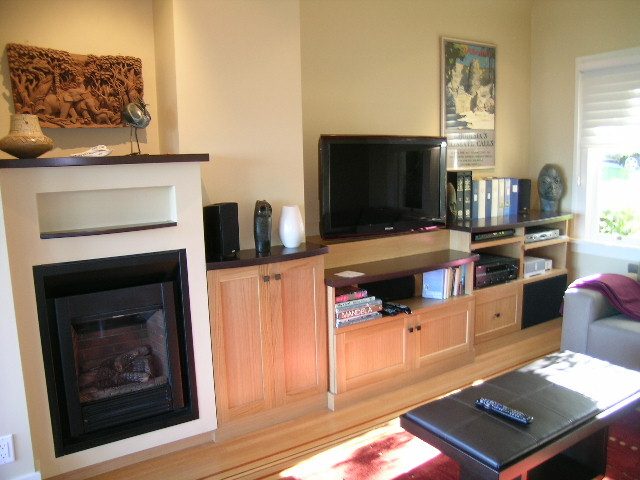 Living room with wooden cabinets, fireplace, and large TV. - 4663 Bellevue Drive, Vancouver West Side
