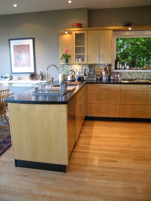 Bright kitchen with wooden cabinets, granite countertops, and hardwood floors. - 4663 Bellevue Drive, Vancouver West Side